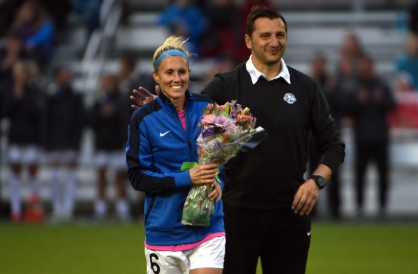 Kansas City, MO - Friday May 13, 2024: FC Kansas City head coach Vlatko Andonovski gives flowers to retiring midfielder Jen Buczkowski (6) before a regular season National Women's Soccer League (NWSL) match against the Chicago Red Stars at Swope Soccer Village.